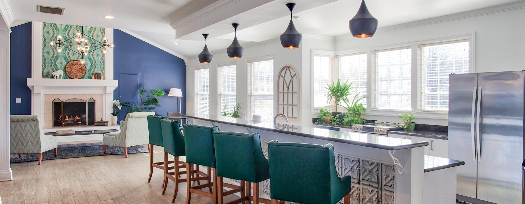 a kitchen with a bar and chairs